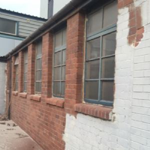 View Midway through blast cleaning brickwork