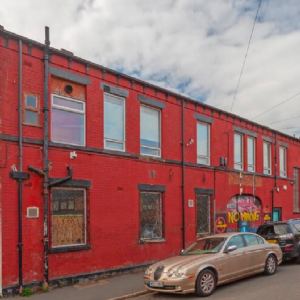 View Brick building covered in red paint